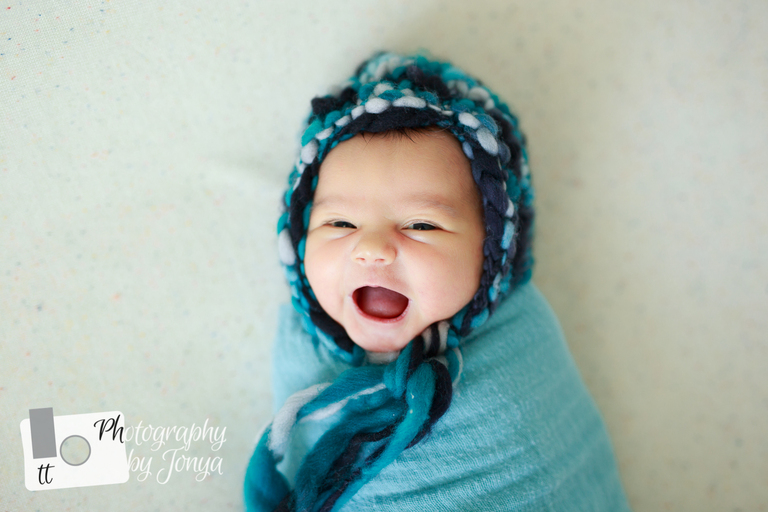 Studio newborn photography in Raleigh nc, smiling newborn baby photo